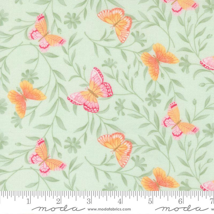 Butterfly pattern fabric with a ruler for scale on a light green background