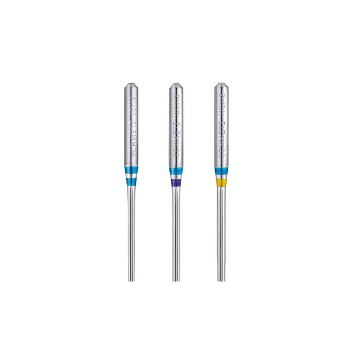 Three Schmetz Jeans/denim needles with colored bands on a white background