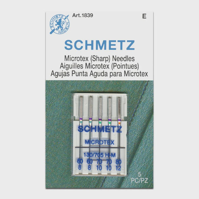Pack of Schmetz Microtex needles assorted sizes on a gray background