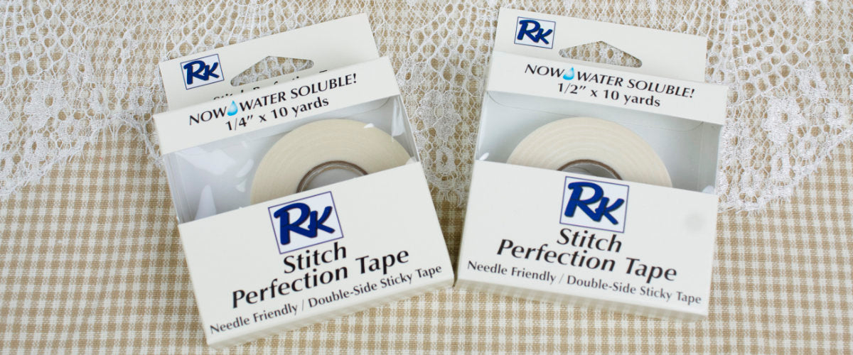 Two packages of RNK Stitch Perfection Tape on a checkered fabric background